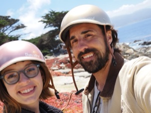 Neil Holt and his wife Tessa wearing helmets by the coast